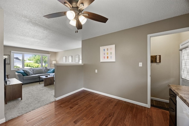 2985 4th St, Marion, IA 52302 - unfurnished living room with wood finished floors, a ceiling fan, a textured ceiling, and baseboards