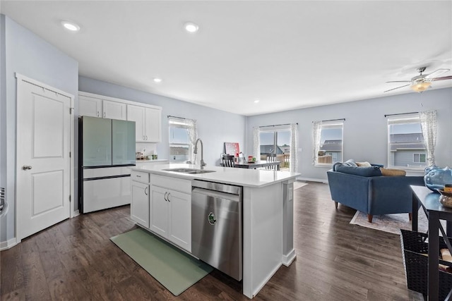 2890 Meadow Ct, Hiawatha, IA 52233 - kitchen with stainless steel dishwasher, freestanding refrigerator, a sink, open floor plan, and white cabinets