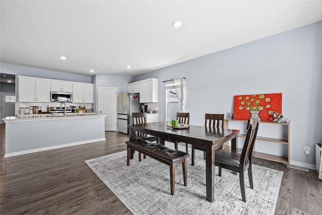 2890 Meadow Ct, Hiawatha, IA 52233 - dining area with dark wood-style flooring, recessed lighting, and baseboards