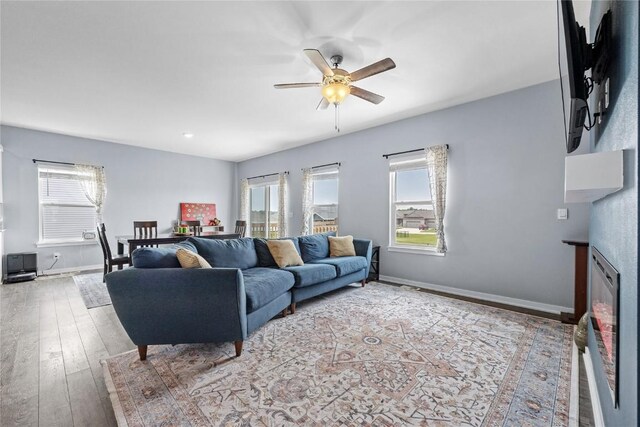 2890 Meadow Ct, Hiawatha, IA 52233 - living area featuring healthy amount of natural light, ceiling fan, hardwood / wood-style floors, and baseboards