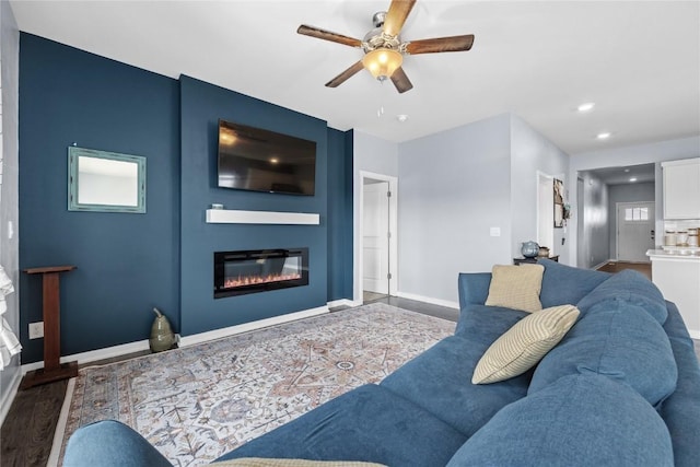 2890 Meadow Ct, Hiawatha, IA 52233 - living room featuring ceiling fan, a glass covered fireplace, baseboards, recessed lighting, and wood finished floors