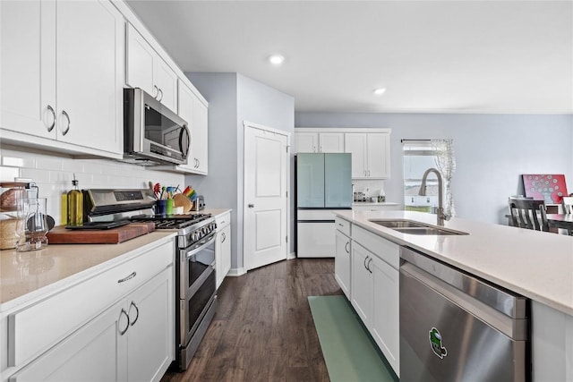 2890 Meadow Ct, Hiawatha, IA 52233 - kitchen featuring stainless steel appliances, a sink, light countertops, white cabinets, and tasteful backsplash