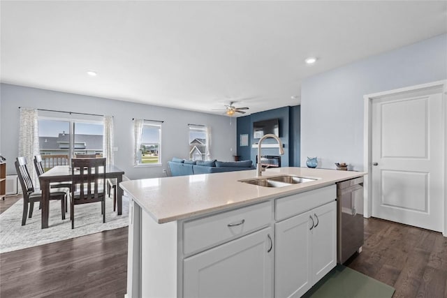 2890 Meadow Ct, Hiawatha, IA 52233 - kitchen featuring a sink, dark wood-style flooring, dishwasher, a ceiling fan, and an island with sink