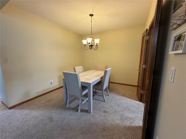 4610 Westchester Dr NE Unit A, Cedar Rapids, IA 52402 - carpeted dining room with a chandelier, a textured ceiling, and baseboards