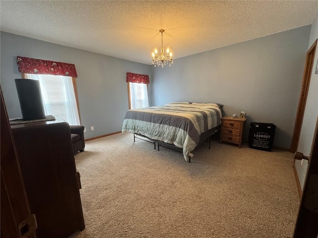 4610 Westchester Dr NE Unit A, Cedar Rapids, IA 52402 - carpeted bedroom featuring a chandelier, a textured ceiling, and baseboards