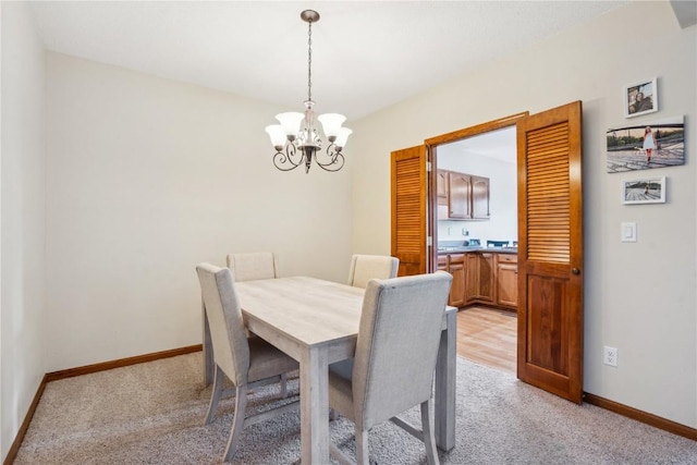 4610 Westchester Dr NE Unit A, Cedar Rapids, IA 52402 - dining space featuring light carpet, a chandelier, and baseboards