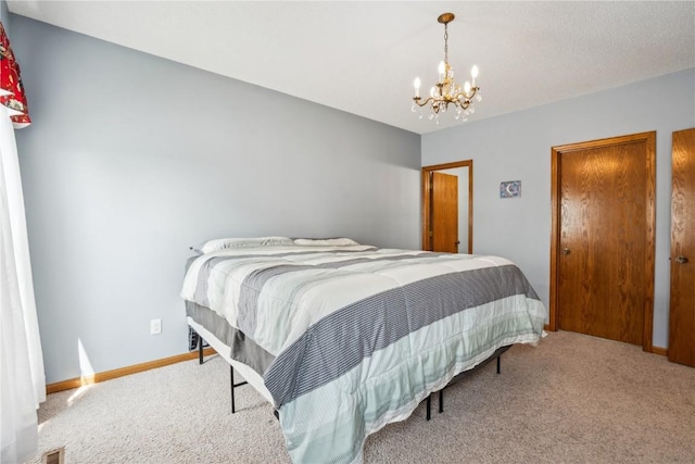 4610 Westchester Dr NE Unit A, Cedar Rapids, IA 52402 - bedroom with carpet floors, a chandelier, and baseboards