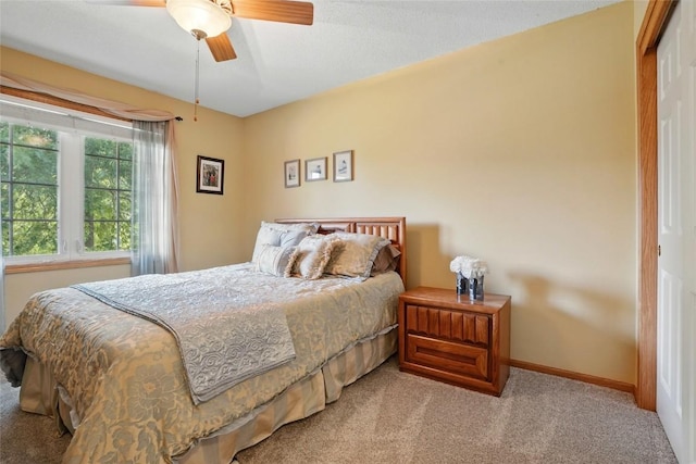 7025 Walden Rd NE, Cedar Rapids, IA 52402 - bedroom with carpet, baseboards, and a ceiling fan