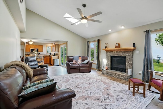 7025 Walden Rd NE, Cedar Rapids, IA 52402 - living area with healthy amount of natural light, a ceiling fan, light wood-style floors, a fireplace, and recessed lighting