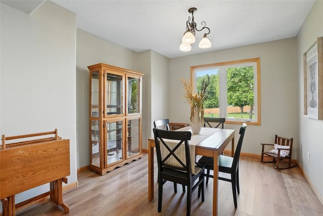 7025 Walden Rd NE, Cedar Rapids, IA 52402 - dining space featuring light wood-type flooring, a chandelier, and baseboards