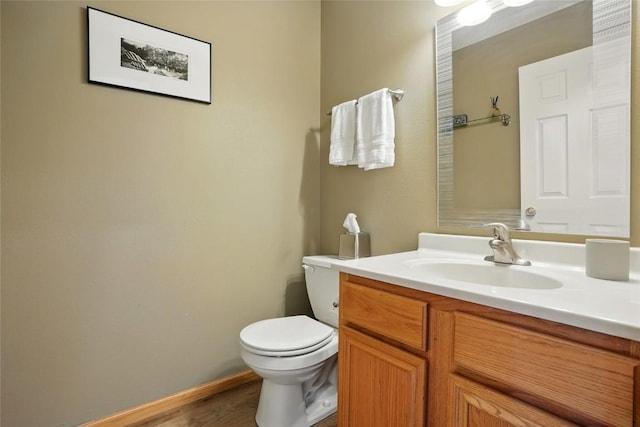 7025 Walden Rd NE, Cedar Rapids, IA 52402 - bathroom featuring vanity, toilet, and wood finished floors