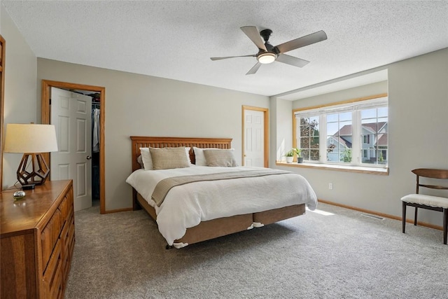 7025 Walden Rd NE, Cedar Rapids, IA 52402 - bedroom featuring carpet, baseboards, a textured ceiling, and a ceiling fan