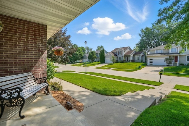 7025 Walden Rd NE, Cedar Rapids, IA 52402 - view of green lawn featuring a residential view, concrete driveway, and a garage