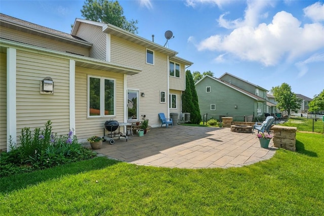 7025 Walden Rd NE, Cedar Rapids, IA 52402 - back of property with an outdoor fire pit, a lawn, a patio area, and cooling unit