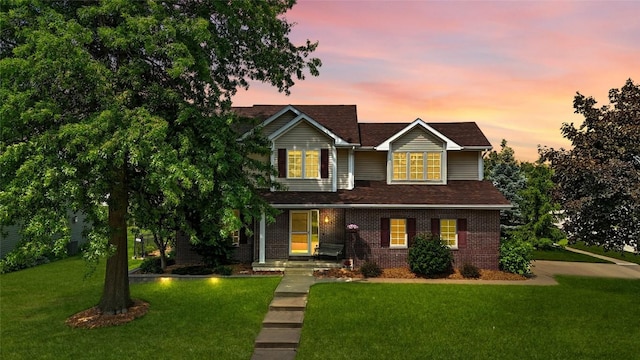 7025 Walden Rd NE, Cedar Rapids, IA 52402 - traditional-style home featuring a yard and brick siding