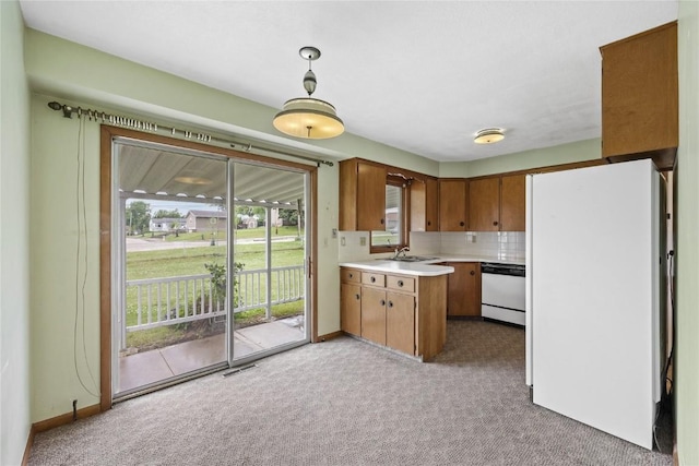 2430 Victoria Dr SW, Cedar Rapids, IA 52404 - kitchen with white appliances, carpet, a sink, and light countertops