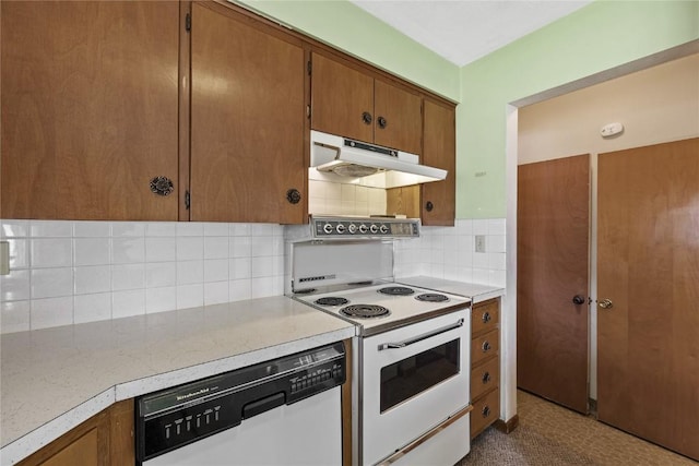 2430 Victoria Dr SW, Cedar Rapids, IA 52404 - kitchen featuring under cabinet range hood, white appliances, brown cabinets, and light countertops