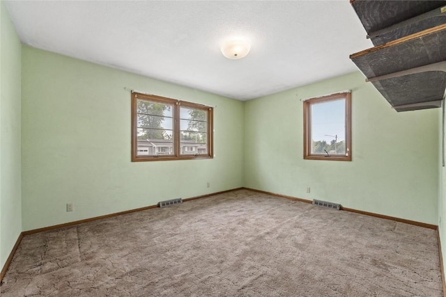 2430 Victoria Dr SW, Cedar Rapids, IA 52404 - carpeted empty room featuring plenty of natural light and baseboards