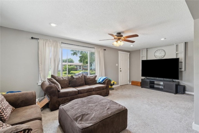 1026 Eisenhower Rd, Hiawatha, IA 52233 - carpeted living room featuring a ceiling fan, a textured ceiling, recessed lighting, and baseboards