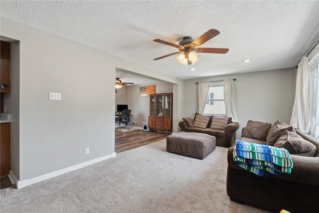 1026 Eisenhower Rd, Hiawatha, IA 52233 - carpeted living room with a ceiling fan, an office area, a textured ceiling, baseboards, and recessed lighting