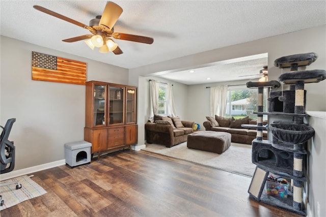 1026 Eisenhower Rd, Hiawatha, IA 52233 - living room with a ceiling fan, dark wood-style floors, baseboards, and a textured ceiling