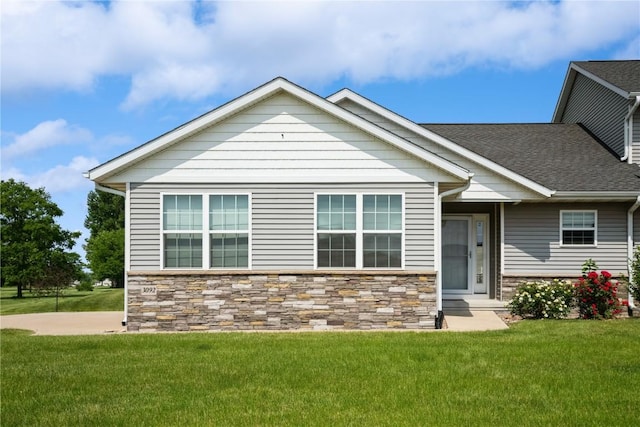 3092 Sherwood Dr, Marion, IA 52302 - view of front facade featuring a front lawn, stone siding, and roof with shingles