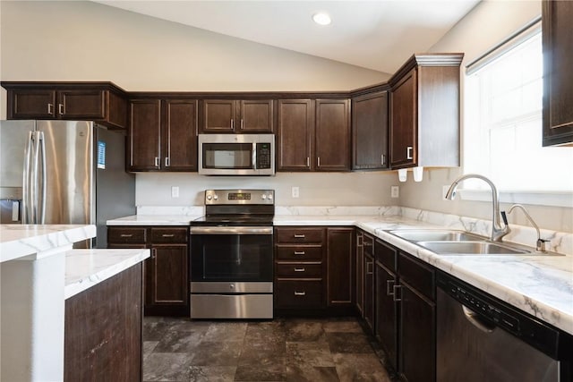 3092 Sherwood Dr, Marion, IA 52302 - kitchen featuring stainless steel appliances, lofted ceiling, dark brown cabinets, light stone counters, and stone finish floors
