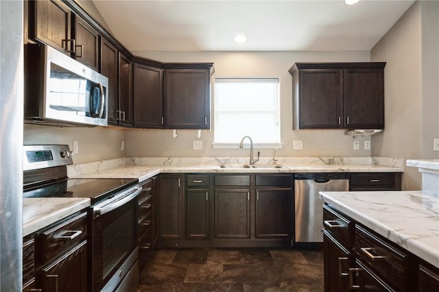 3092 Sherwood Dr, Marion, IA 52302 - kitchen featuring stainless steel appliances, dark brown cabinetry, stone finish flooring, light stone counters, and recessed lighting