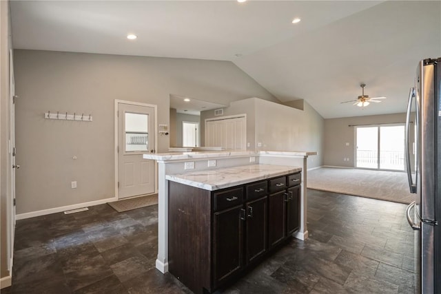 3092 Sherwood Dr, Marion, IA 52302 - kitchen with freestanding refrigerator, vaulted ceiling, a ceiling fan, open floor plan, and a kitchen island
