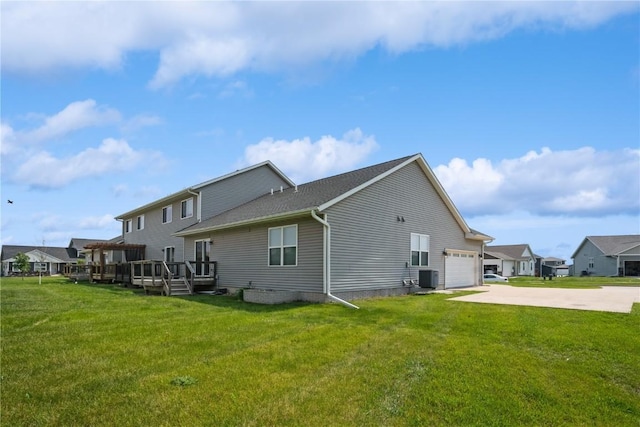 3092 Sherwood Dr, Marion, IA 52302 - back of property with driveway, a deck, an attached garage, and a lawn