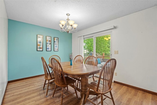 6813 Terrazzo Dr NW, Cedar Rapids, IA 52405 - dining space with a chandelier, light wood-type flooring, baseboards, and a textured ceiling