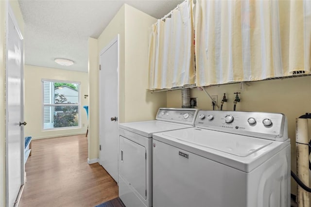 6813 Terrazzo Dr NW, Cedar Rapids, IA 52405 - laundry area featuring light wood-type flooring, washing machine and clothes dryer, and baseboards