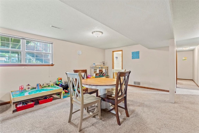 6813 Terrazzo Dr NW, Cedar Rapids, IA 52405 - dining area with light carpet, a textured ceiling, and baseboards