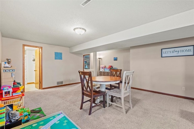 6813 Terrazzo Dr NW, Cedar Rapids, IA 52405 - dining room with carpet, baseboards, and a textured ceiling