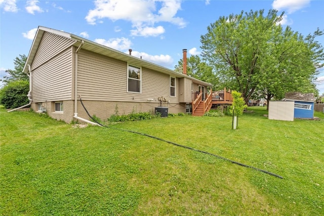 6813 Terrazzo Dr NW, Cedar Rapids, IA 52405 - rear view of house featuring a wooden deck, a yard, stairway, and central air condition unit