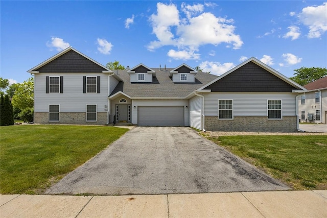 4555 Westchester Dr NE Unit A, Cedar Rapids, IA 52402 - view of front of property with driveway, an attached garage, brick siding, a front yard, and roof with shingles