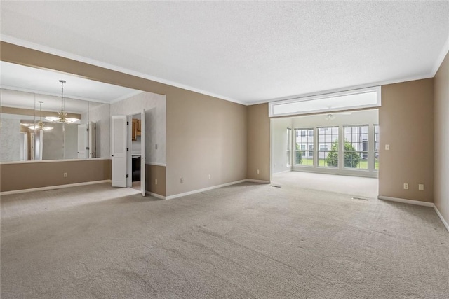 4555 Westchester Dr NE Unit A, Cedar Rapids, IA 52402 - unfurnished living room featuring ornamental molding, carpet floors, baseboards, a chandelier, and a textured ceiling