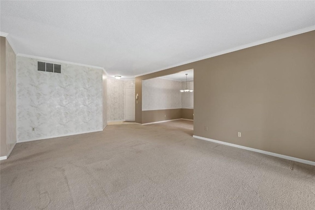 4555 Westchester Dr NE Unit A, Cedar Rapids, IA 52402 - carpeted empty room featuring ornamental molding, a chandelier, baseboards, and a textured ceiling