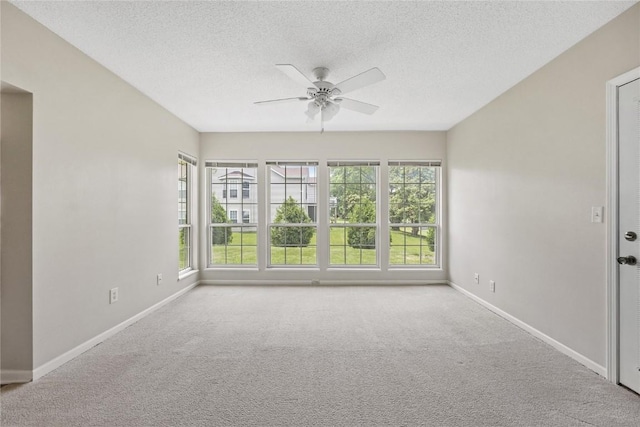 4555 Westchester Dr NE Unit A, Cedar Rapids, IA 52402 - carpeted spare room featuring ceiling fan, baseboards, and a textured ceiling