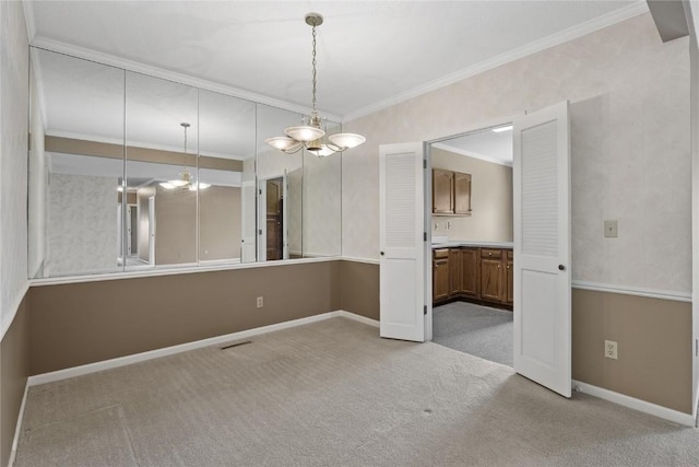 4555 Westchester Dr NE Unit A, Cedar Rapids, IA 52402 - carpeted spare room with ornamental molding, baseboards, and a chandelier