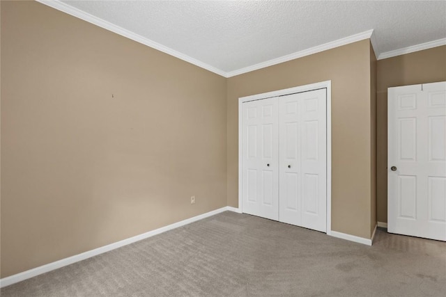 4555 Westchester Dr NE Unit A, Cedar Rapids, IA 52402 - unfurnished bedroom featuring carpet floors, ornamental molding, a closet, baseboards, and a textured ceiling