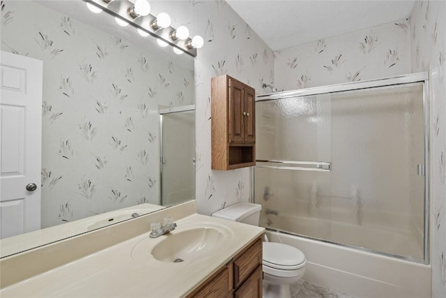 4555 Westchester Dr NE Unit A, Cedar Rapids, IA 52402 - bathroom featuring wallpapered walls, vanity, toilet, and bath / shower combo with glass door