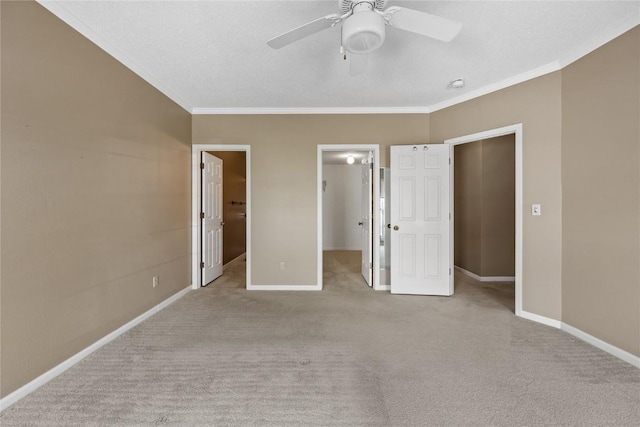4555 Westchester Dr NE Unit A, Cedar Rapids, IA 52402 - unfurnished bedroom with a walk in closet, crown molding, carpet, baseboards, and a closet