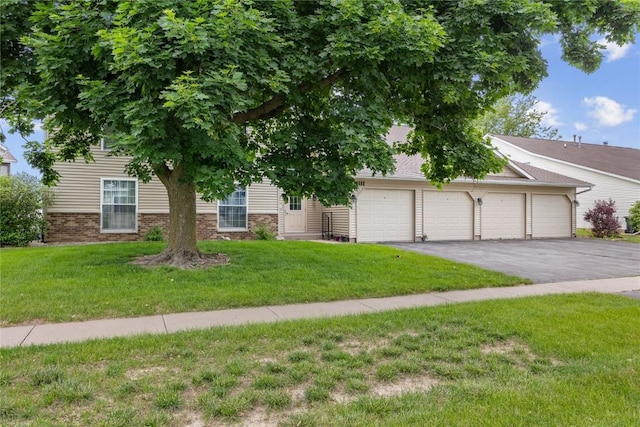 4111 Blue Jay Dr NE Unit A, Cedar Rapids, IA 52402 - view of front of home with asphalt driveway, a front yard, an attached garage, and brick siding