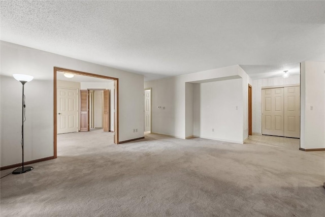 4111 Blue Jay Dr NE Unit A, Cedar Rapids, IA 52402 - unfurnished room featuring light carpet, baseboards, and a textured ceiling