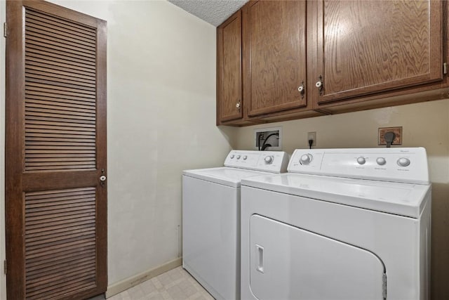 4111 Blue Jay Dr NE Unit A, Cedar Rapids, IA 52402 - laundry area with cabinet space, independent washer and dryer, baseboards, light flooring, and a textured ceiling