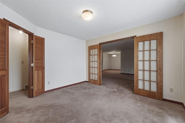 4111 Blue Jay Dr NE Unit A, Cedar Rapids, IA 52402 - unfurnished room with french doors, carpet, and baseboards