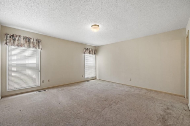 4111 Blue Jay Dr NE Unit A, Cedar Rapids, IA 52402 - carpeted empty room with healthy amount of natural light, baseboards, and a textured ceiling