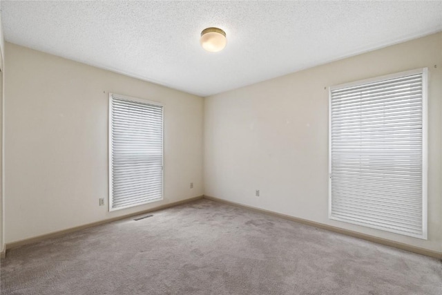 4111 Blue Jay Dr NE Unit A, Cedar Rapids, IA 52402 - carpeted spare room with baseboards and a textured ceiling