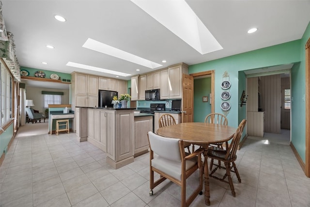 4324 C Ave NE, Cedar Rapids, IA 52402 - dining space featuring a skylight, light tile patterned floors, and recessed lighting